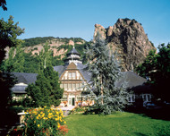House in front of bizarre rock formation in Bad Mnster am Stein